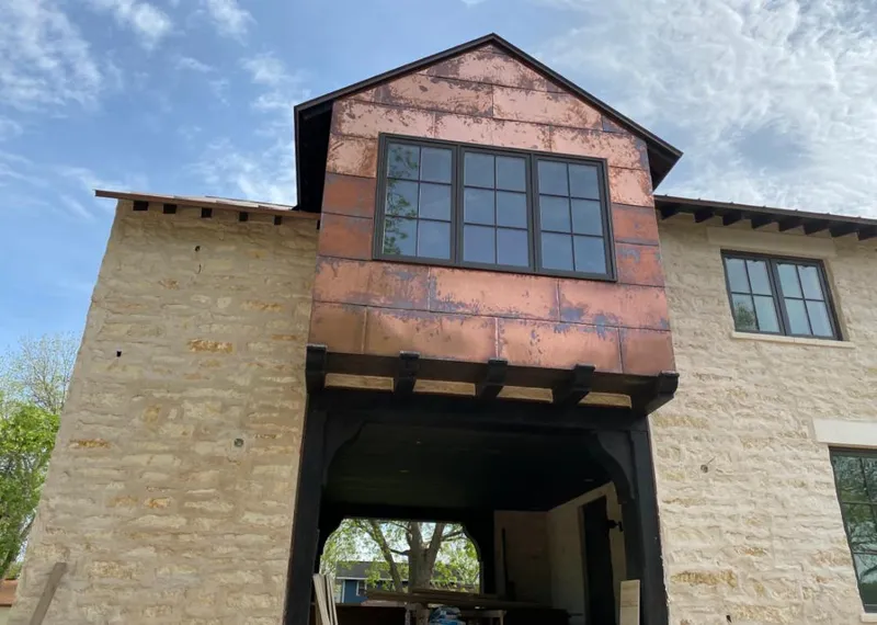 Copper metal panel facade on a stone building for Metal Roof Coating in Otsego